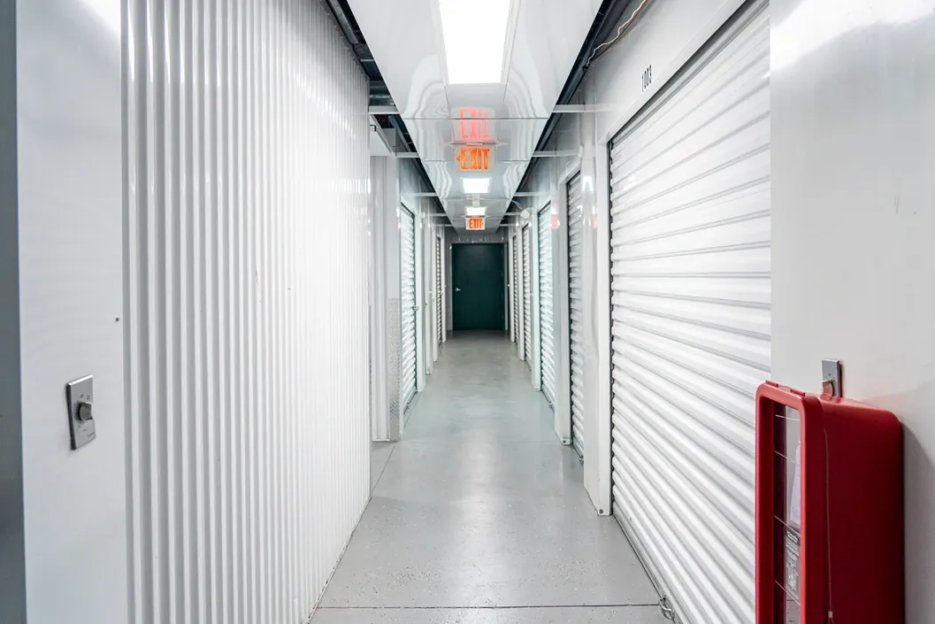 Climate-controlled indoor storage hallway with secure roll-up units